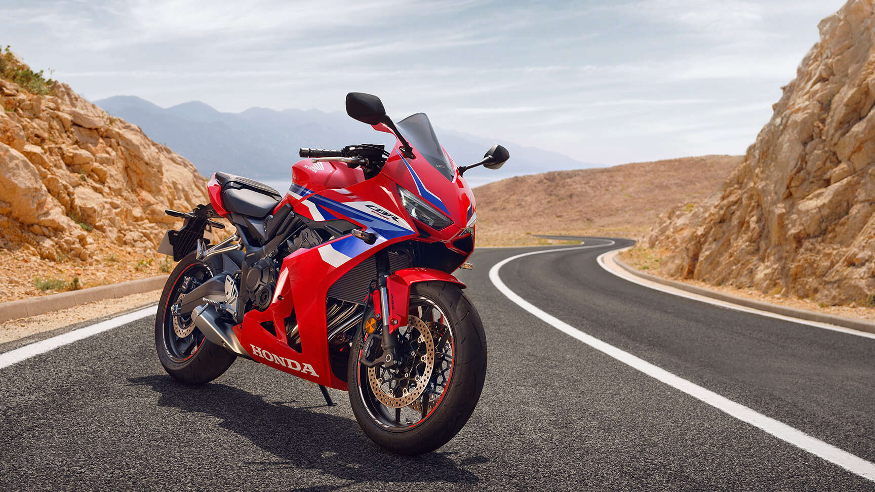 Oldalra készült felvétel a Honda CBR650R modellről vízparti úton.